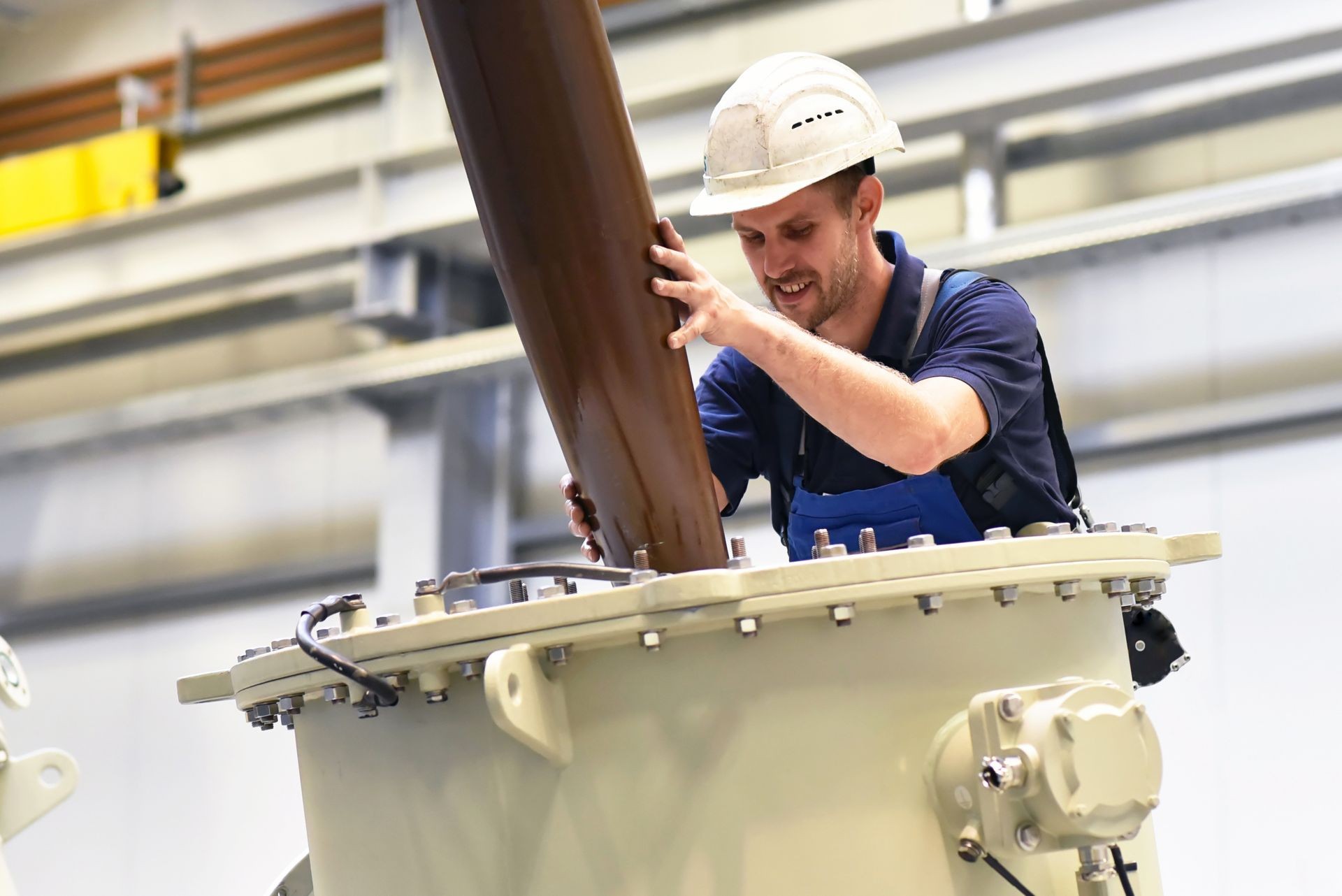 operator installs a transformer in an industrial plant in mechanical engineering 