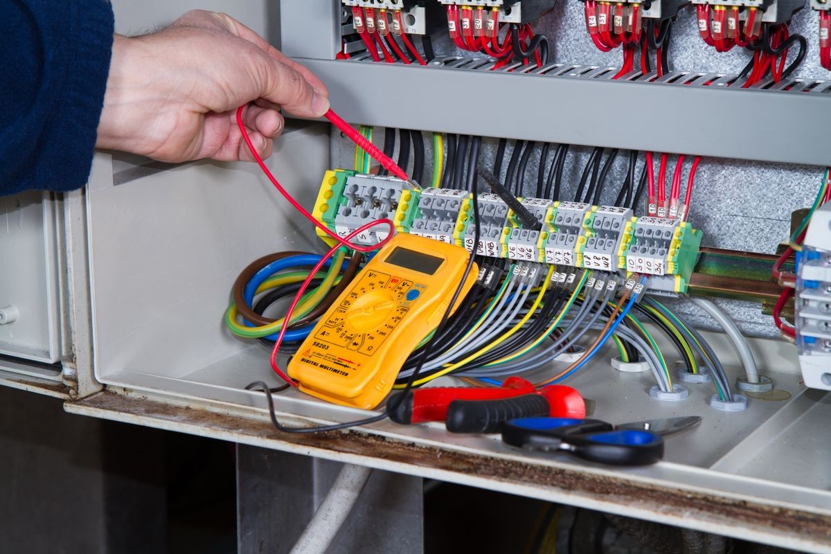 electrician at work with an electric panel