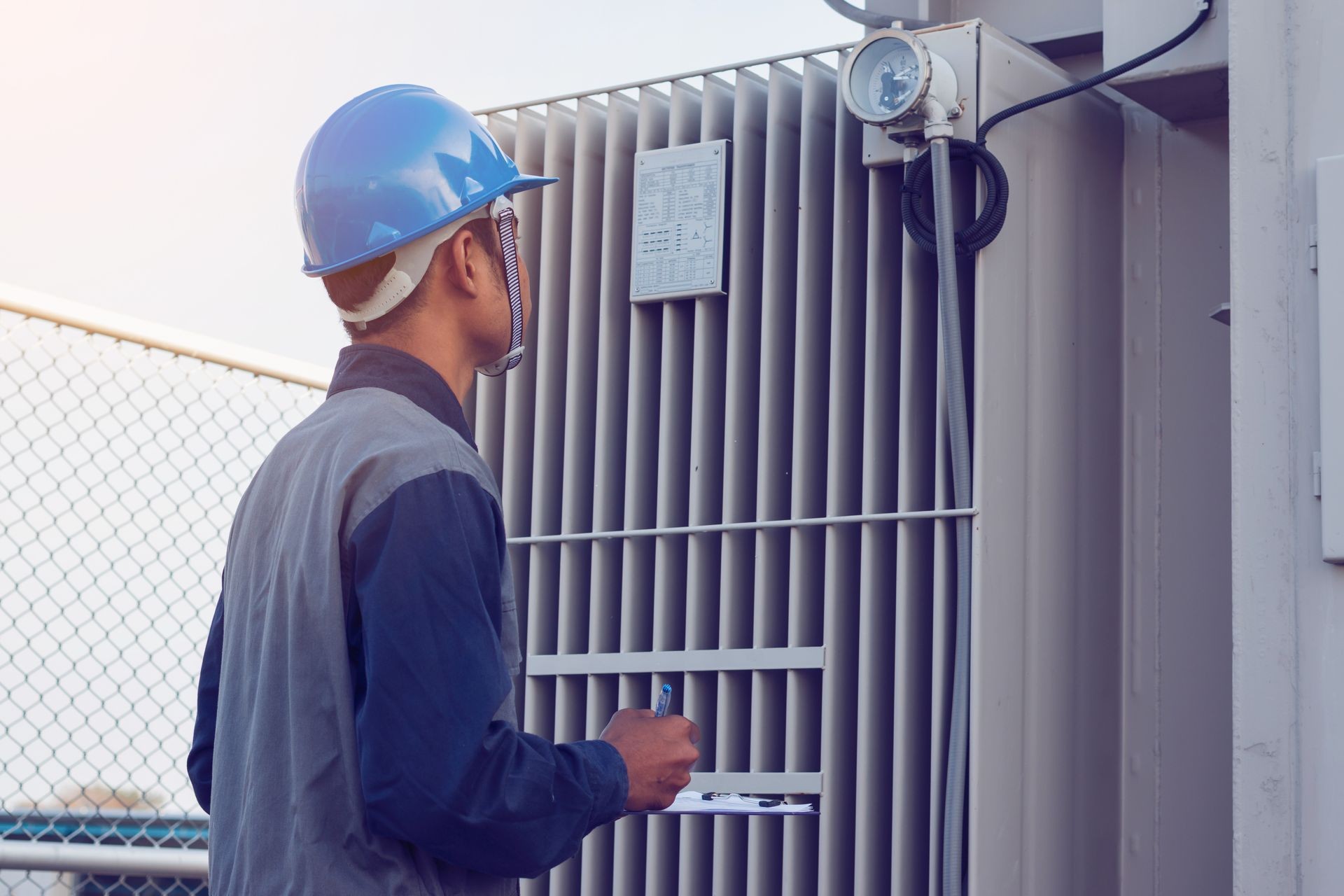 engineer or electrician working on checking status step up transformer high voltage on transformer yard and solution problem to operate at green energy solar power plant
