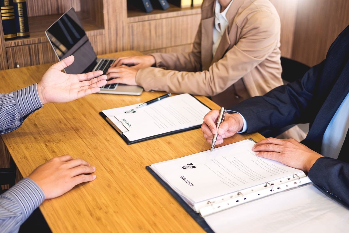 young man explaining about his profile to business managers sitting in job Interview. listen to candidate answers Hiring employee, nervously clutched scolded by boss